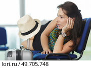 woman layed across chairs while waiting in airport. Стоковое фото, агентство Ingram Publishing / Фотобанк Лори