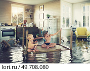 kids pday on the table while flooding in the kitchen. Photo and media photocombination. Стоковое фото, агентство Ingram Publishing / Фотобанк Лори
