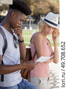 disgruntled mixed race couple looking at map on holiday. Стоковое фото, агентство Ingram Publishing / Фотобанк Лори