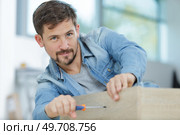 a happy man fixing a furniture. Стоковое фото, агентство Ingram Publishing / Фотобанк Лори
