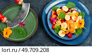 Vitamin fruit salad with banana, strawberries, grapes and nasturtium. Tasty fruit salad with edible nasturtium. Стоковое фото, агентство Ingram Publishing / Фотобанк Лори