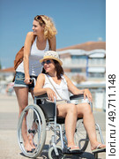 woman with friend in a wheelchair on a summer outing. Стоковое фото, агентство Ingram Publishing / Фотобанк Лори