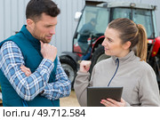 two agronomists with laptop and tablet in wheat field. Стоковое фото, агентство Ingram Publishing / Фотобанк Лори