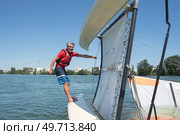 salior trying to right his catamaran after capsize. Стоковое фото, агентство Ingram Publishing / Фотобанк Лори