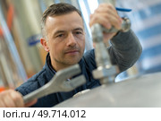 factory man worker measuring detail with vernier caliper at workshop. Стоковое фото, агентство Ingram Publishing / Фотобанк Лори
