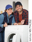 happy man and woman delivering washing machine. Стоковое фото, агентство Ingram Publishing / Фотобанк Лори