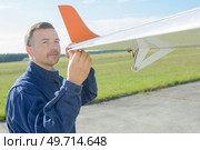 engineer flying remote control glider. Стоковое фото, агентство Ingram Publishing / Фотобанк Лори