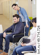 woman pushing man in a wheelchair. Стоковое фото, агентство Ingram Publishing / Фотобанк Лори