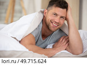 calm young handsome bearded man lying in bed. Стоковое фото, агентство Ingram Publishing / Фотобанк Лори
