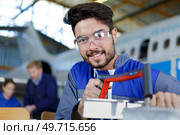 man working on an aircraft hangar. Стоковое фото, агентство Ingram Publishing / Фотобанк Лори