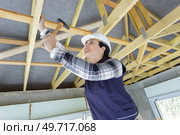 a woman worker in the carpenter workroom renovation. Стоковое фото, агентство Ingram Publishing / Фотобанк Лори