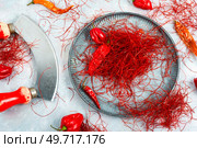 Spicy seasoning, spice, cut from red pepper. Thinly sliced pepper.. Cutting red chilly peppers. Стоковое фото, агентство Ingram Publishing / Фотобанк Лори