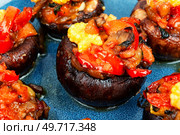 Mushroom, champignons caps baked stuffed with bell pepper and corn. Close up. Plate with delicious stuffed mushrooms. Стоковое фото, агентство Ingram Publishing / Фотобанк Лори
