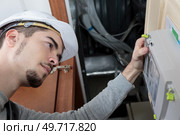 lineman checking the panel. Стоковое фото, агентство Ingram Publishing / Фотобанк Лори