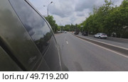 A car is driving down a road with a cloudy sky in the background. Стоковое видео, видеограф Ярославский Максим / Фотобанк Лори