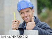 cheerful and successful construction worker posing showing thumbs up. Стоковое фото, агентство Ingram Publishing / Фотобанк Лори
