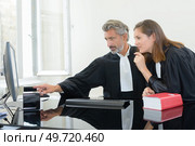 portrait of lawyers examining an evidence. Стоковое фото, агентство Ingram Publishing / Фотобанк Лори