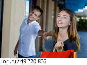 young beautiful woman drags her boyfriend. Стоковое фото, агентство Ingram Publishing / Фотобанк Лори