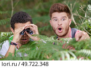 men in bushes getting a shock when looking through binoculars. Стоковое фото, агентство Ingram Publishing / Фотобанк Лори
