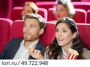 woman unimpressed with the movie scene. Стоковое фото, агентство Ingram Publishing / Фотобанк Лори