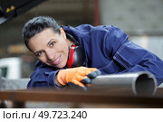 female insulation worker isolating industrial pipe. Стоковое фото, агентство Ingram Publishing / Фотобанк Лори
