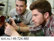 two men working together to operate machine drill. Стоковое фото, агентство Ingram Publishing / Фотобанк Лори
