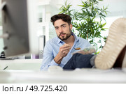 satisfied businessman checking the pc. Стоковое фото, агентство Ingram Publishing / Фотобанк Лори