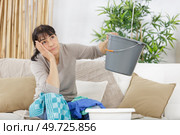 frustrated woman during leaking roof or pipe burst. Стоковое фото, агентство Ingram Publishing / Фотобанк Лори