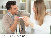 enamoured couple finding out results of a pregnancy test. Стоковое фото, агентство Ingram Publishing / Фотобанк Лори