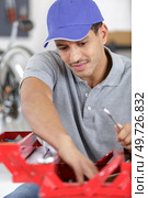 orker in a blue combo box with a tool box. Стоковое фото, агентство Ingram Publishing / Фотобанк Лори