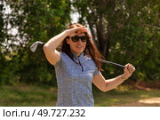Golfing Woman Shielding Her Eyes on a Sunny Afternoon at the Club. Стоковое фото, фотограф Aleksandr Golubev / Фотобанк Лори