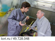 a professional metallurgist with apprentice. Стоковое фото, агентство Ingram Publishing / Фотобанк Лори
