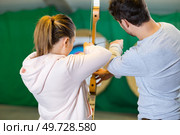 portrait of people practicing indoor archery. Стоковое фото, агентство Ingram Publishing / Фотобанк Лори