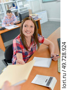 someone is handing over a folder. Стоковое фото, агентство Ingram Publishing / Фотобанк Лори