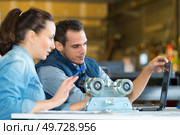 a couple of workers toil around the milling machine factory. Стоковое фото, агентство Ingram Publishing / Фотобанк Лори