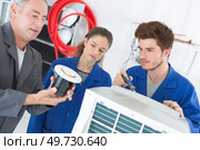teacher showing a small equipment. Стоковое фото, агентство Ingram Publishing / Фотобанк Лори
