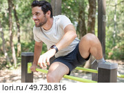 man vaulting hurdles in the park. Стоковое фото, агентство Ingram Publishing / Фотобанк Лори