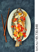 Grilled tilapia fish with fruit in white plate. Healthy food concept. Asian food.. A view of a plate of fried tilapia. Стоковое фото, агентство Ingram Publishing / Фотобанк Лори