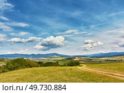 Slovakia summer landscape. Green summer fields, meadows, hills of Tatra mountains. Travel in vacations. Rural Road in Spis region, Slovakia. Spissky hrad national park on background. Стоковое фото, агентство Ingram Publishing / Фотобанк Лори
