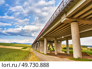 Motorway viaduct bridge, Spis region, Slovakia. Autostrada highway in Europe. D1 magistal near Spissky hrad, arched bridge. Green summer fields, hills of Tatra mountains. Travel in vacations. Стоковое фото, агентство Ingram Publishing / Фотобанк Лори