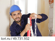 a happy male builder indoors. Стоковое фото, агентство Ingram Publishing / Фотобанк Лори