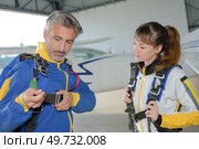 a parachutist is fastening harness. Стоковое фото, агентство Ingram Publishing / Фотобанк Лори