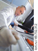 podiatrist reaching towards camera for implement. Стоковое фото, агентство Ingram Publishing / Фотобанк Лори
