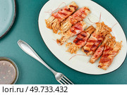 Roasted enoki mushrooms with bacon on the plate. Asian cuisine. Enoki mushrooms rolls, asian food. Стоковое фото, агентство Ingram Publishing / Фотобанк Лори