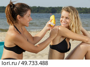 two women putting cream. Стоковое фото, агентство Ingram Publishing / Фотобанк Лори
