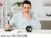 annoyed about breaking piggy bank. Стоковое фото, агентство Ingram Publishing / Фотобанк Лори