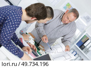 students and teacher in architecture working on project. Стоковое фото, агентство Ingram Publishing / Фотобанк Лори