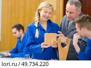 carpenter trainees learning with boss. Стоковое фото, агентство Ingram Publishing / Фотобанк Лори