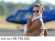 smiling girl next to an helicopter. Стоковое фото, агентство Ingram Publishing / Фотобанк Лори