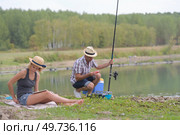 young couple fishing or angling on lake shore. Стоковое фото, агентство Ingram Publishing / Фотобанк Лори